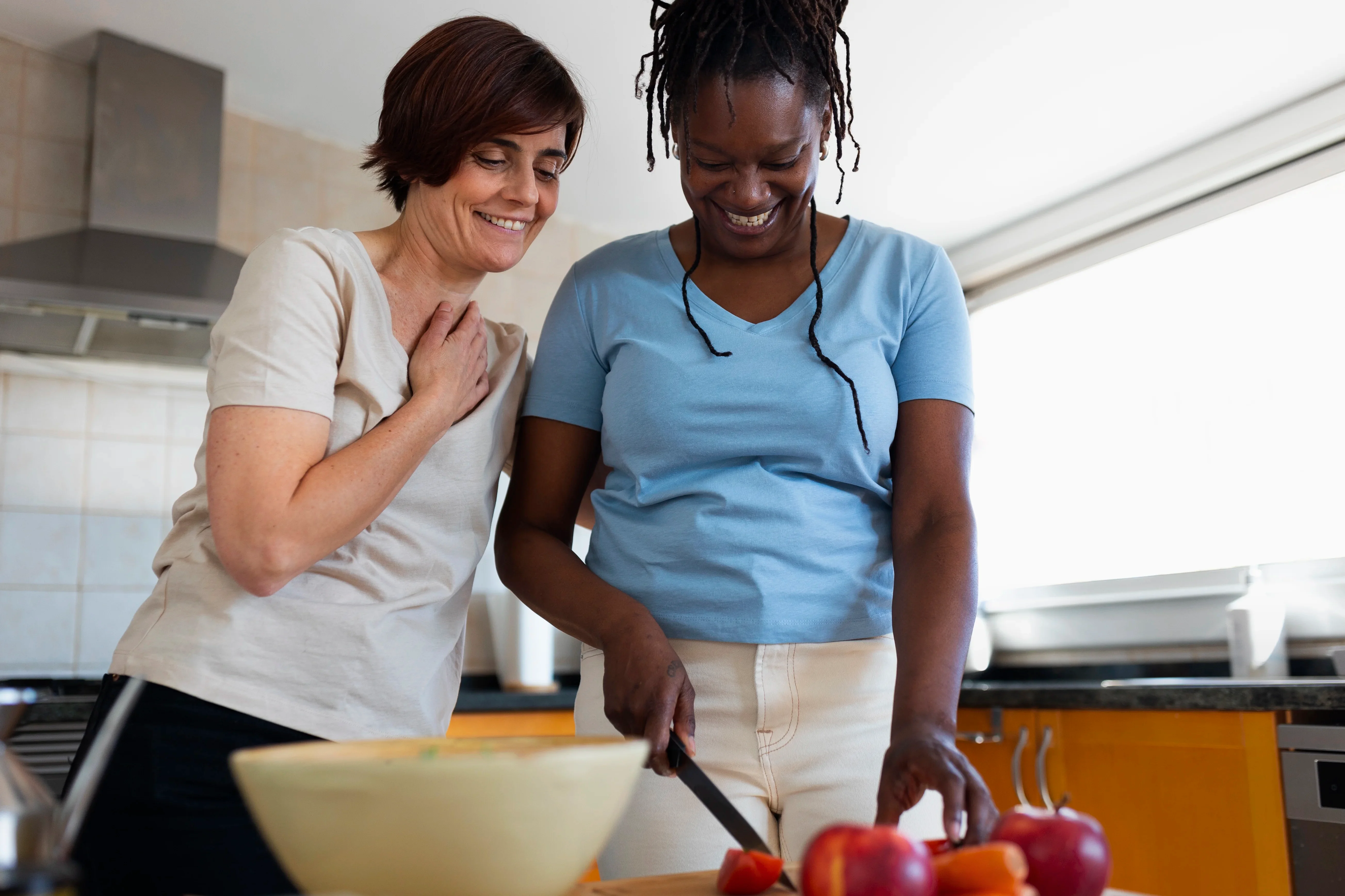 Two people cooking a meal together in their kitchen