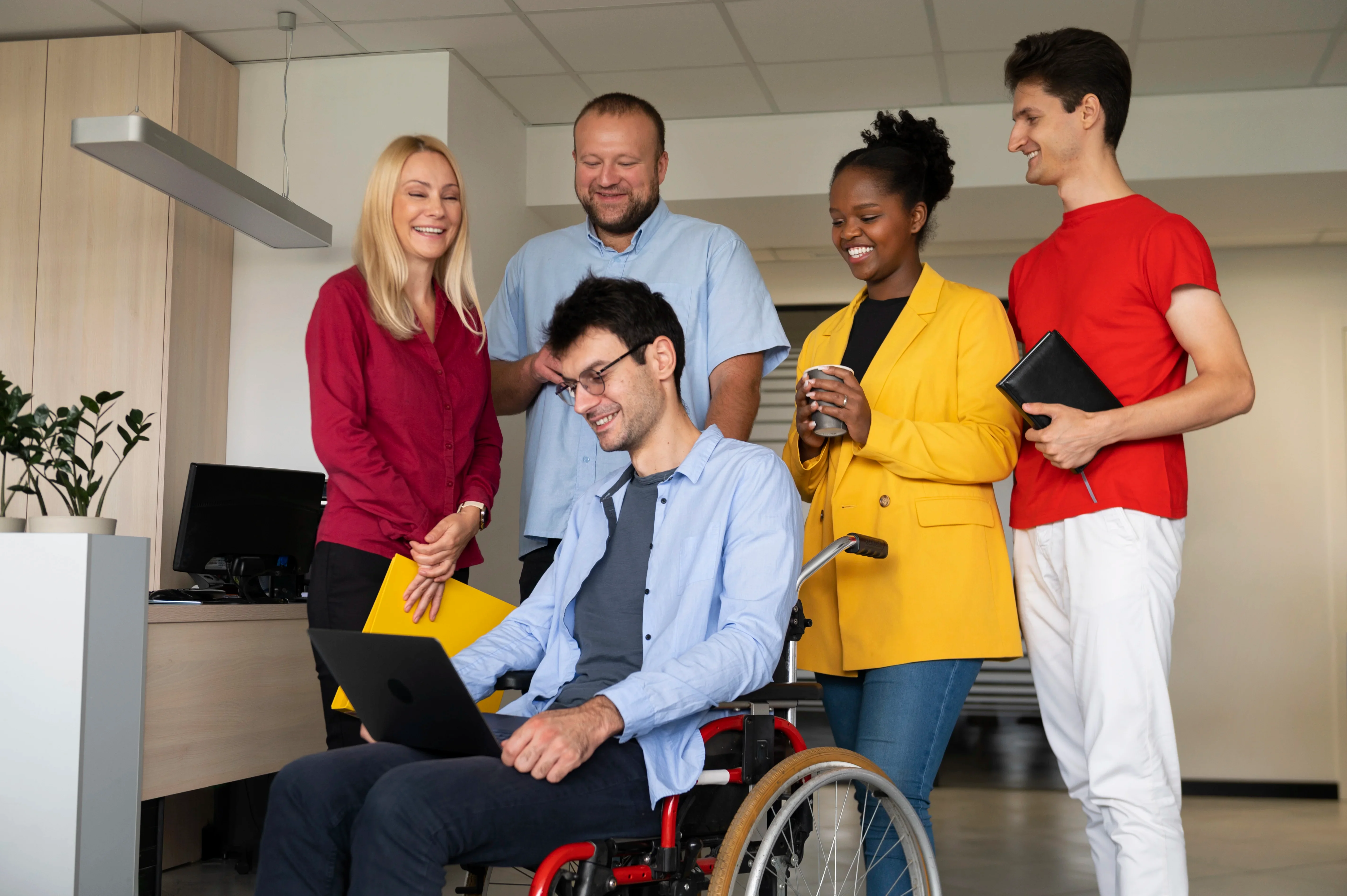 A diverse team of smiling support workers collaborating
