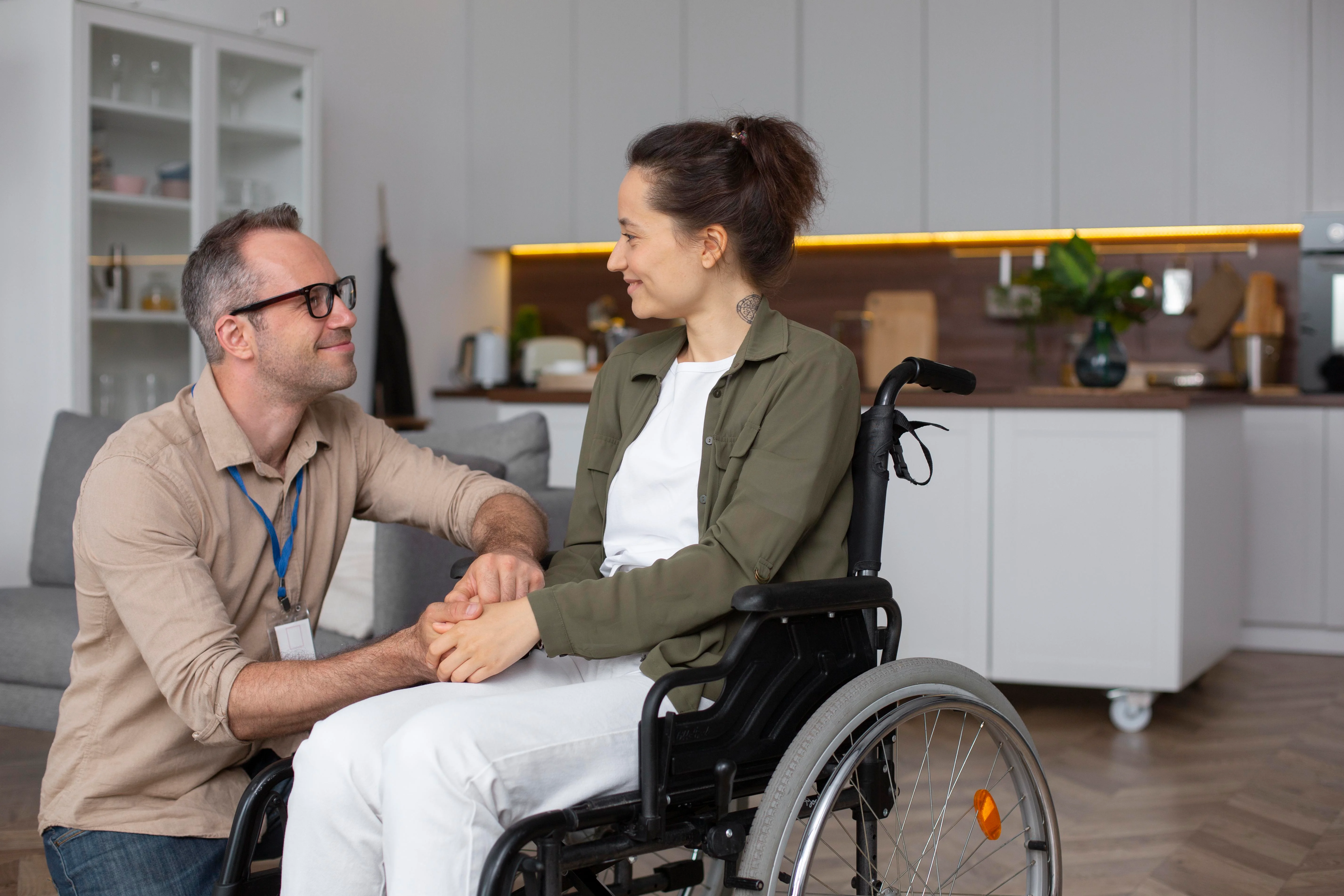 A woman sitting in a wheelchair, smiling